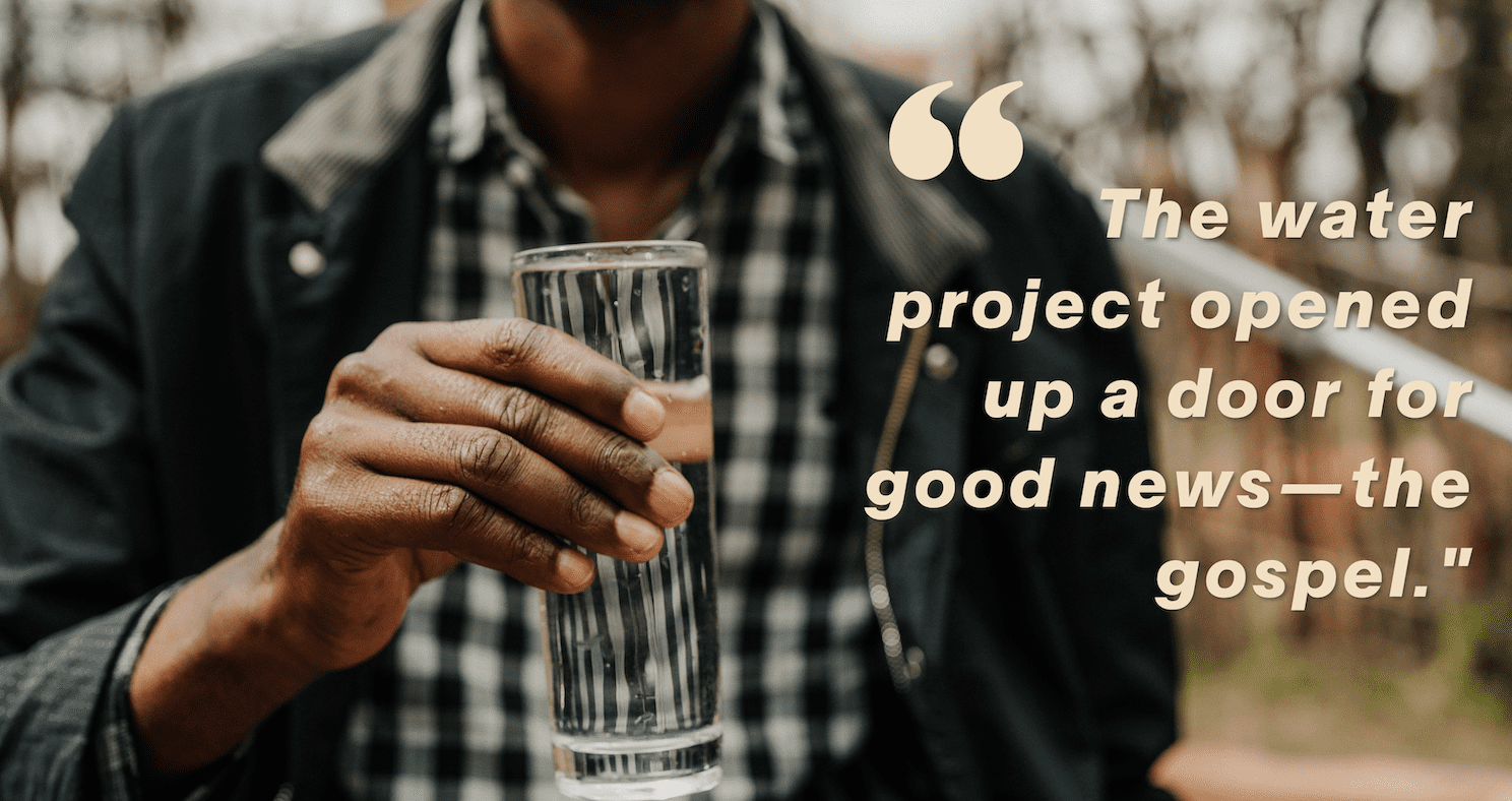 A person holds a clear glass of water; next to them is text that reads, The water project opened up a door for good news—the gospel.